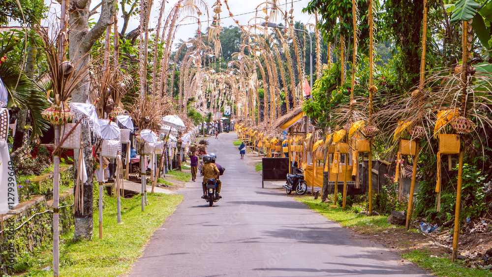 Bali Penjors, decorated bamboo poles along the village street in Sideman, Indonesia.