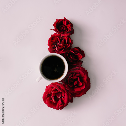 Coffee cup with red roses photo