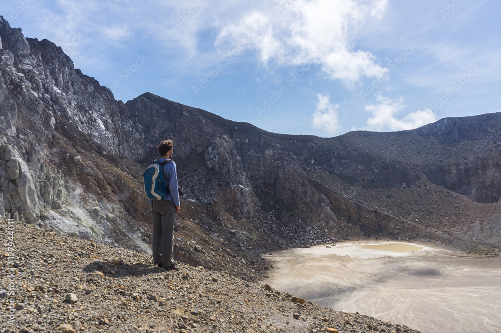 Fototapeta premium Tourist standing in the crater of Mount Egon, Flores, Nusa Tenggara, Indonesia