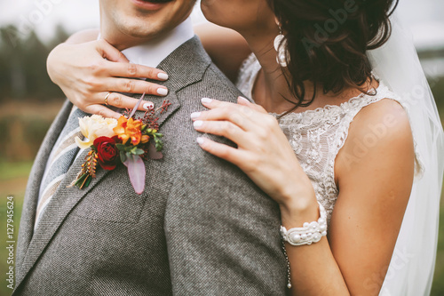 Stylish couple on their autumn wedding day and their accessories: boutonniere, bracelet photo
