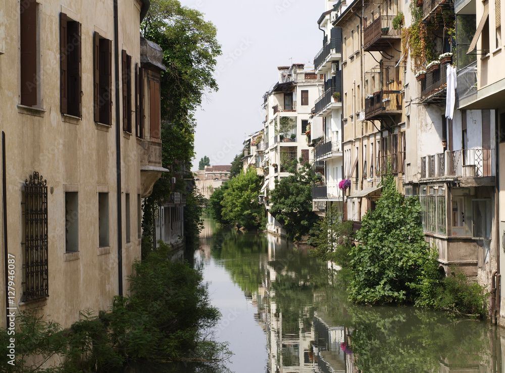 Cityscape of canal  in Padova, ltaly with brown houses