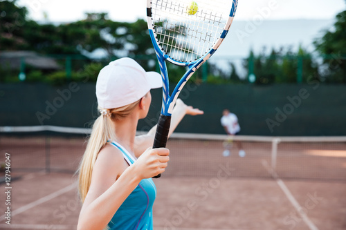 Back view of tennis player serving during a match © Drobot Dean