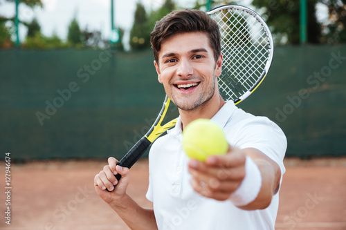 Tennis man giving ball © Drobot Dean