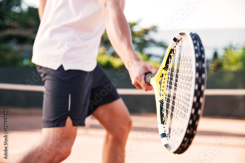 Man playing in tennis © Drobot Dean