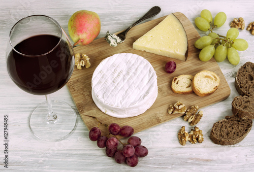 Red wine, cheese, grapes, nuts, with copyspace