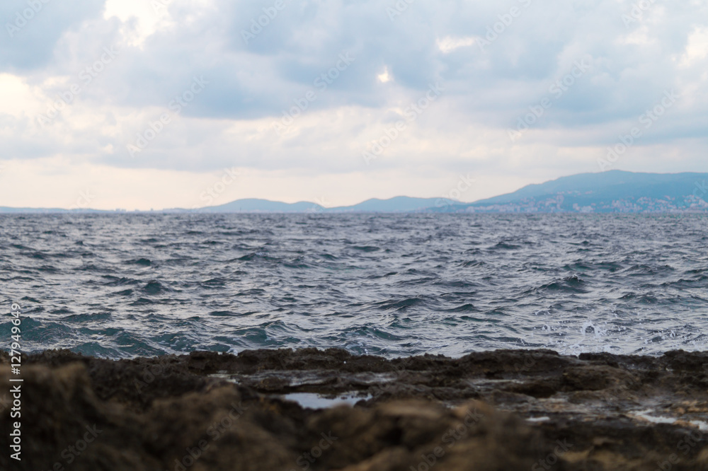 Dark view of coast. Water splashing on rocks. Dark view of coast. Water splashing on rocks.