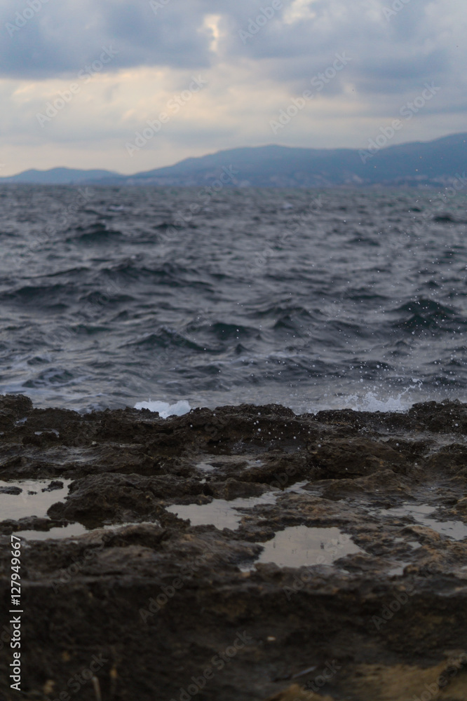 Dark view of coast. Water splashing on rocks. Dark view of coast. Water splashing on rocks.