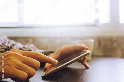 Close up of male hands using Tablet on the desk