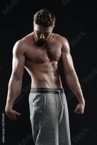 Naked muscular man posing