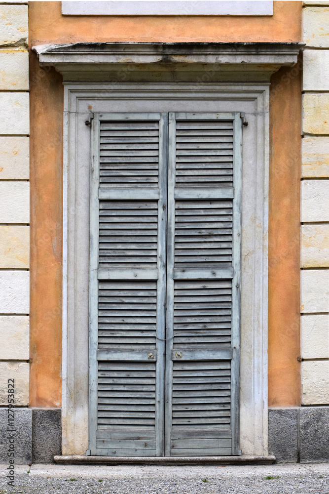 Old door with blue shutters Old door with blue shutters