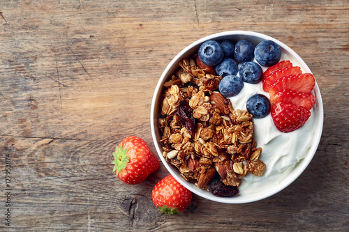 Homemade granola with yogurt and fresh berries photo