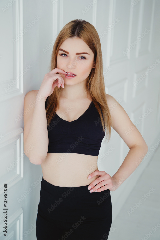 Studio photo of beautiful girl with sportive body, wearing sport clothes Studio photo of beautiful girl with sportive body, wearing sport clothes