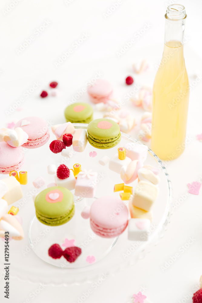 Colorful macaroons, sweet berries, tasty marshmallows and lemonade Colorful macaroons, sweet berries, tasty marshmallows and lemonade