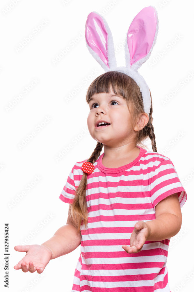 Happy little girl with pink rabbit ears. Portrait of cute caucasian baby wearing bunny ears. Funny preschool child, isolated on white background. Healthy carefree kid - Easter holidays concepts. Happy little girl with pink rabbit ears. Portrait of cute caucasian baby wearing bunny ears. Funny preschool child, isolated on white background. Healthy carefree kid - Easter holidays concepts.