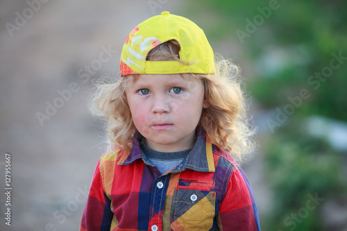 Portrait of little boy wearing yellow cap   
