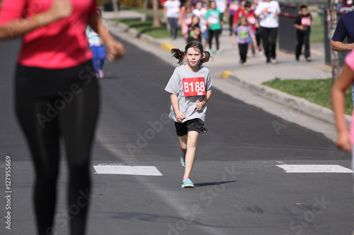 young girl running in race