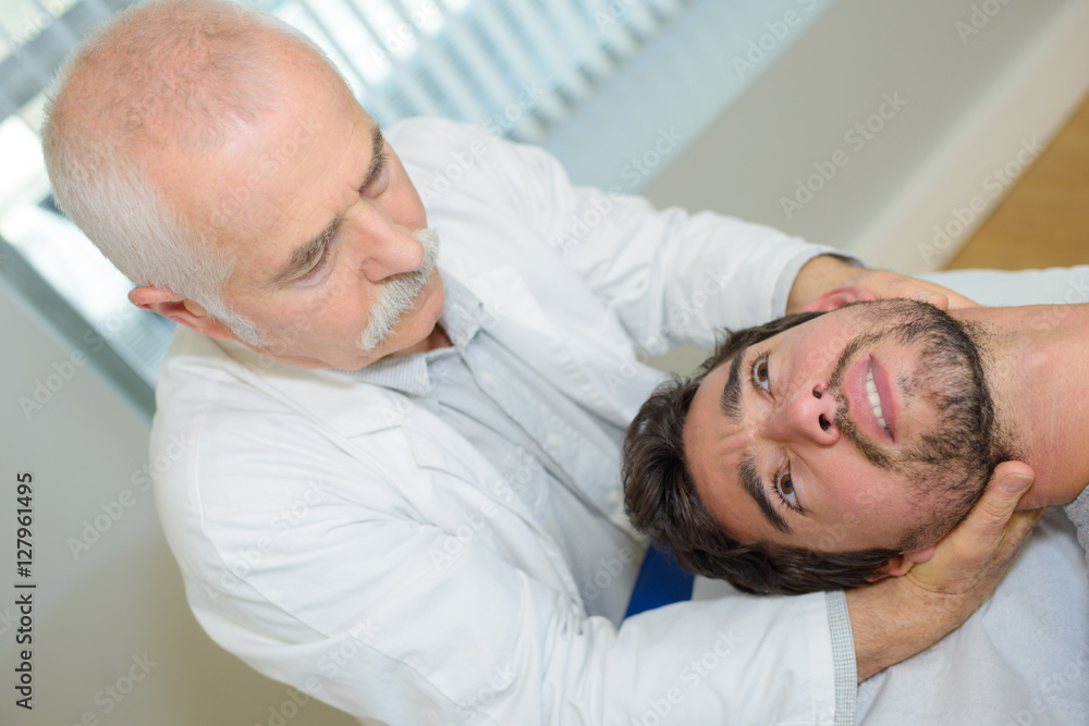 Fototapeta premium man receiving head massage in medical office