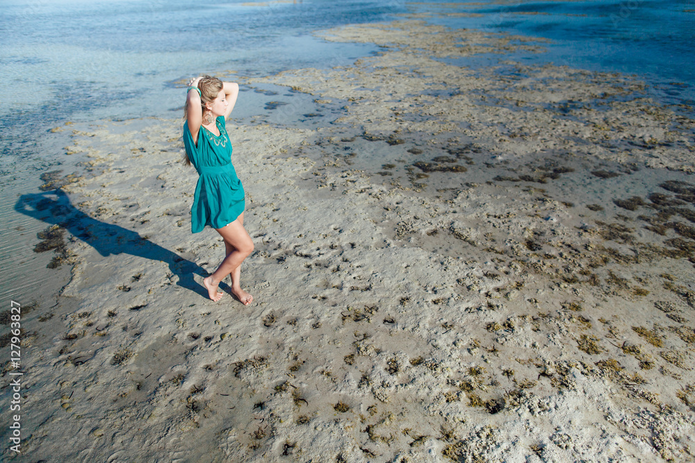 woman girl in turquoise on beach at sea ocean