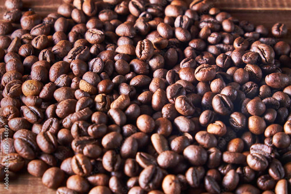 Coffee beans on the wooden background Coffee beans on the wooden background