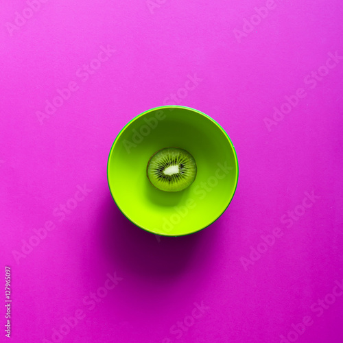 Canvas Print Lime in green bowl on purple background.