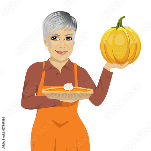 senior woman holding freshly baked homemade pumpkin pie
