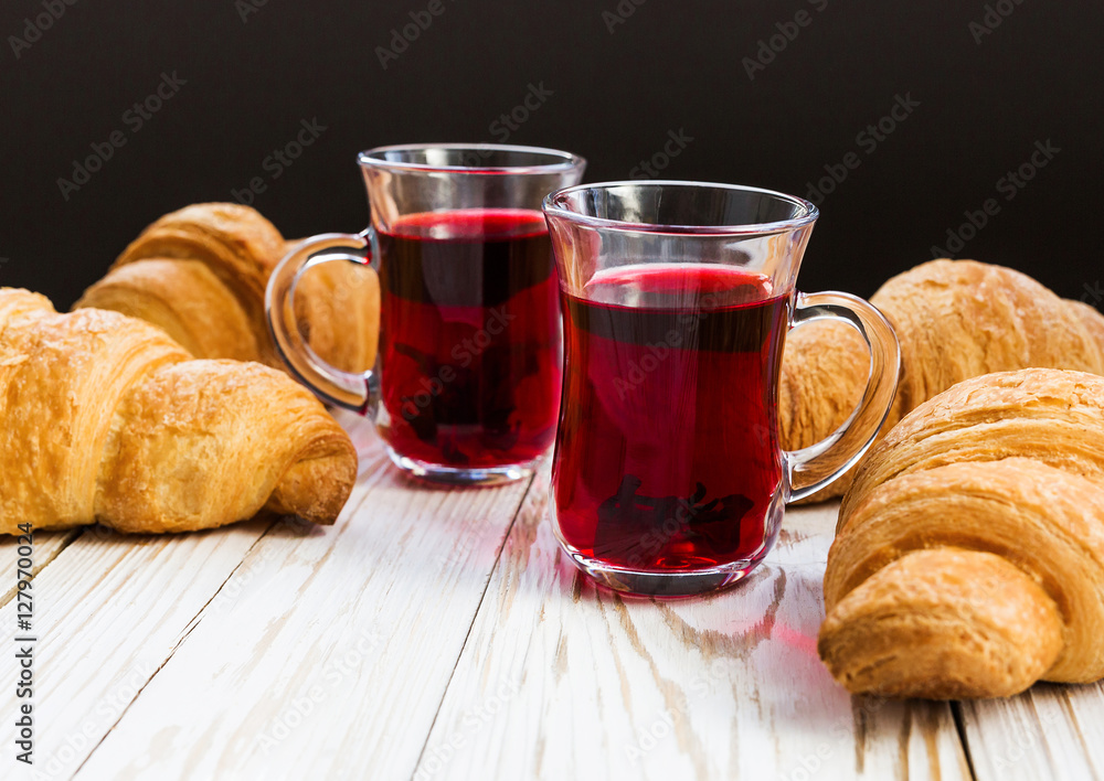 Fresh Croissants and cups of hot hibiscus tea Fresh Croissants and cups of hot hibiscus tea