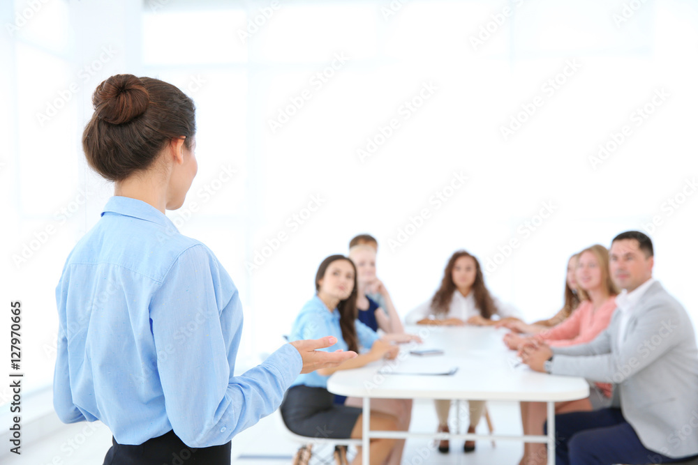 Business trainer giving presentation to group of people Business trainer giving presentation to group of people