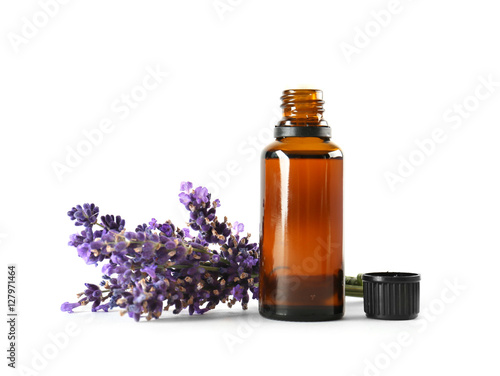 Bottle with aroma oil and lavender flowers isolated on white
