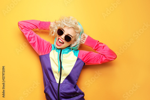 Obraz na płótnie Fashion girl in sportswear on yellow background