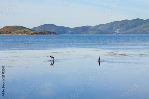 Fishermen are fishing at a lagoon in Song Lo, Phuoc Dong, Nha Trang, Vietnam. Nha Trang is well known for its beaches and scuba diving and has developed into a destination for international tourists.
