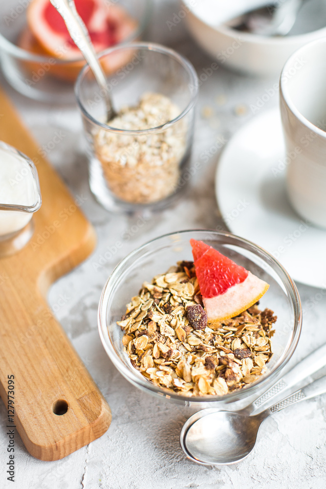 healthy breakfast: granola in bowl with coffe healthy breakfast: granola in bowl with coffe