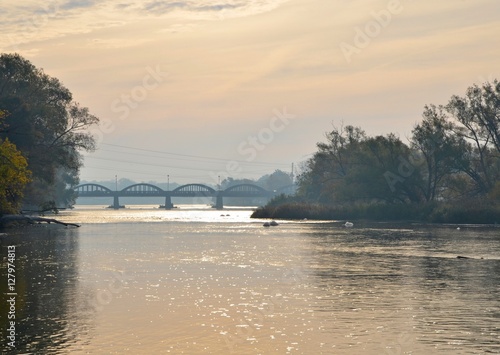 view along the Grand River, with te istoric bridge in the background;  Caledonia, Ontario Canada photo
