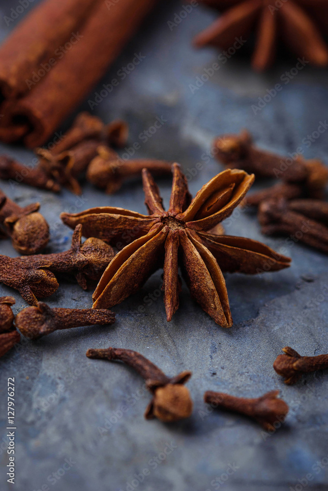 Star anise and cloves on concrete background Star anise and cloves on concrete background