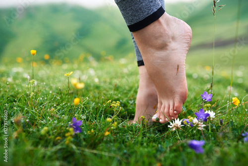 beautiful girls barefoot in cool morning dew on grass. photo