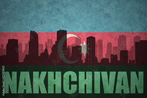 abstract silhouette of the city with text Nakhchivan at the vintage azerbaijan flag photo