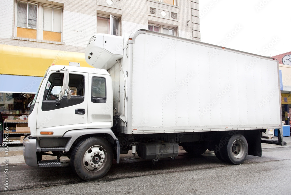 Side view of delivery truck parked on city street. Horizontal. Side view of delivery truck parked on city street. Horizontal.