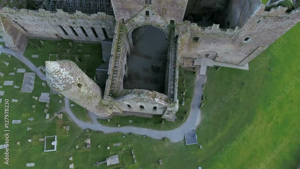 Aerial shot of the ruined Rock of Cashel. The Rock of Cashel is one of Irelands most spectacular archaeological sites a prominent green hill banded with limestone outcrops in Ireland Aerial shot of the ruined Rock of Cashel. The Rock of Cashel is one of Irelands most spectacular archaeological sites a prominent green hill banded with limestone outcrops in Ireland