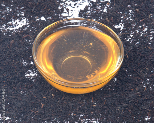 Organic amish farm pure honey in bowl and camellia assam tea