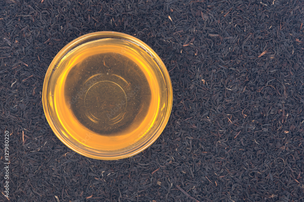 Organic amish farm pure honey in bowl and camellia assam tea Organic amish farm pure honey in bowl and camellia assam tea