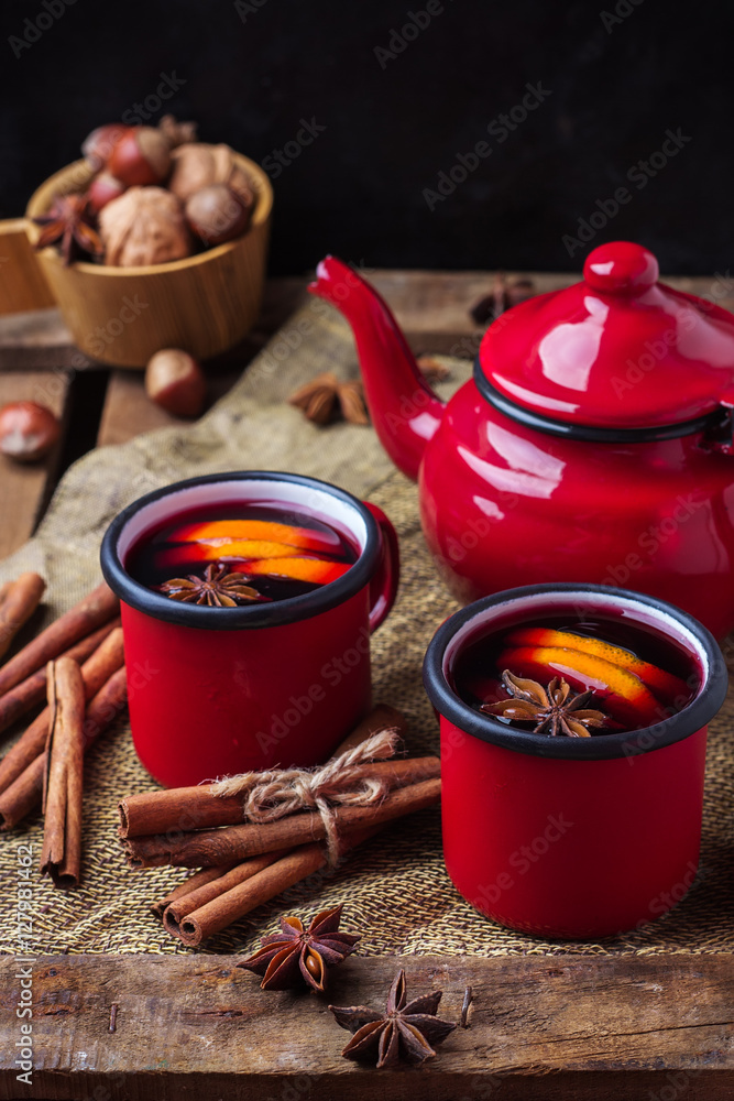 Hot mulled wine in a red mug for winter holidays Hot mulled wine in a red mug for winter holidays