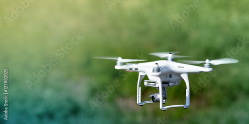 Quadcopter drone flying over a cultivated field