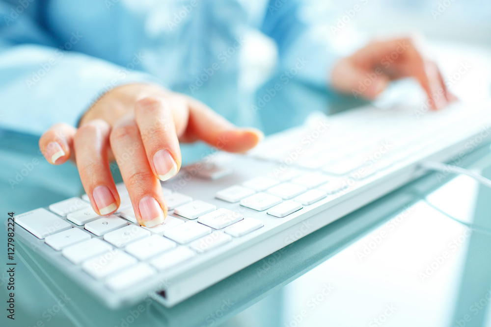 Woman office worker typing on the keyboard Woman office worker typing on the keyboard