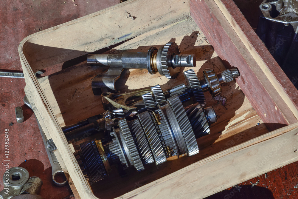 Dismantled box car transmissions. The gears on the shaft of a mechanical transmission