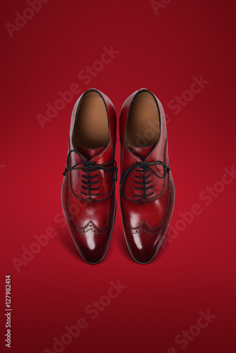 men suede shoes red background