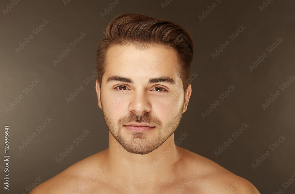 Portrait of young handsome man on grey background Portrait of young handsome man on grey background