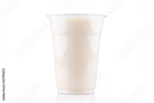Frontal view of banana milkshake in plastic cup