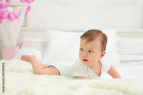 Cute baby lying on bed