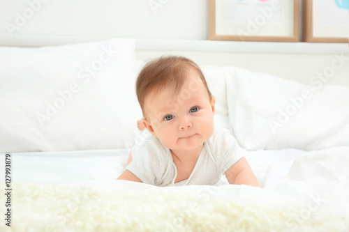 Cute baby lying on bed