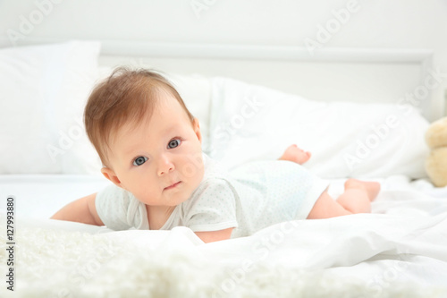 Cute baby lying on bed