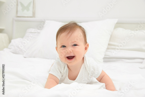 Cute baby lying on bed